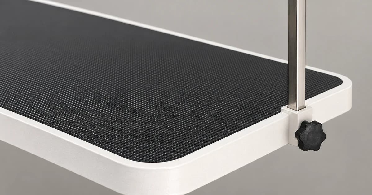 A partial black grooming tabletop with a rounded white edge and an upright section.