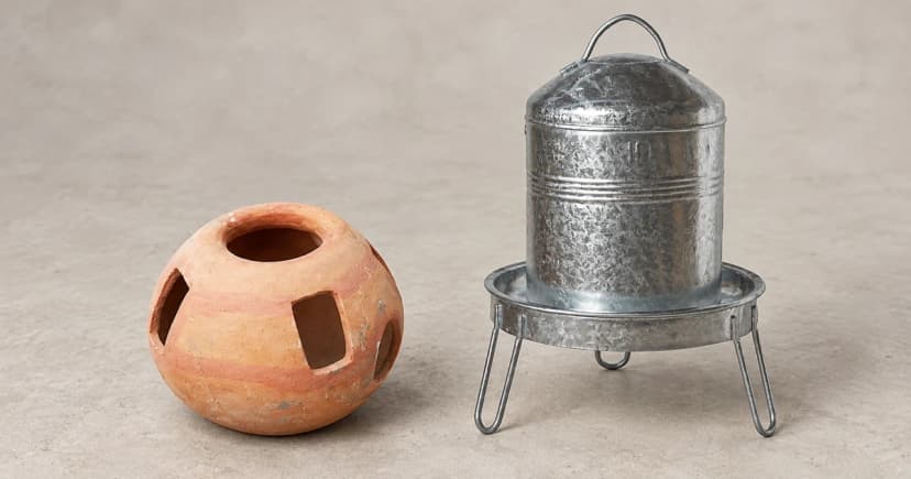 Edited illustration of an orange traditional poultry waterer beside a separate metallic-looking reservoir and drinking pan on three legs